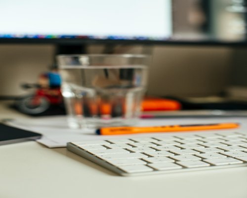 Glass of water near a work desk